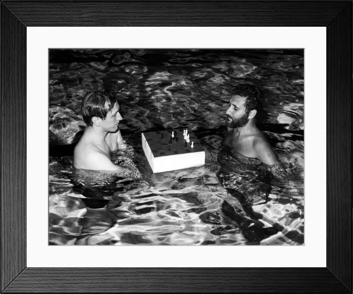 Framed Print : Bobby Fischer plays a chess match with Larry Evans in a indoor pool at the Grossinger Hotel in the Catskills, New York. ca. 1971. Courtesy: CSU Archives / Everett Collection