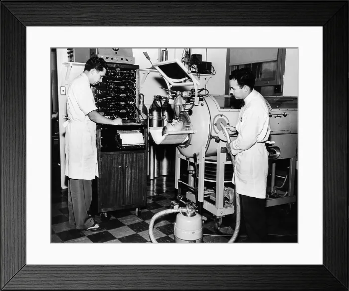 Framed Print : Doctors are studying the mechanism of cough in a polio patient in an Iron Lung respirator. Rancho Los Amigos Respirator Center, Hondo, California. 1953 Framed Print : Doctors are studying the mechanism of cough in a polio patient in an Iron Lung respirator. Rancho Los Amigos Respirator Center, Hondo, California. 1953