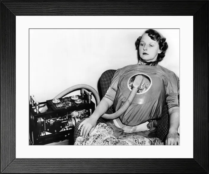 Framed Print : A portable respirator for polio victims, on display in London. Worn like a blouse, the respirator may be plugged into an electrical outlet or powered by a battery