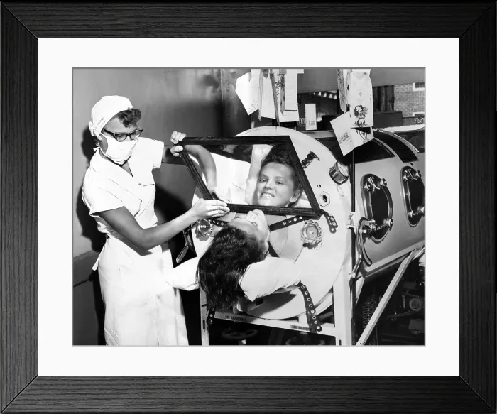 Framed Print : Polio patient Flossie Rogers looking at the world through the mirror of her iron lung in June 1957. She recovered and became a nurse in the same hospital