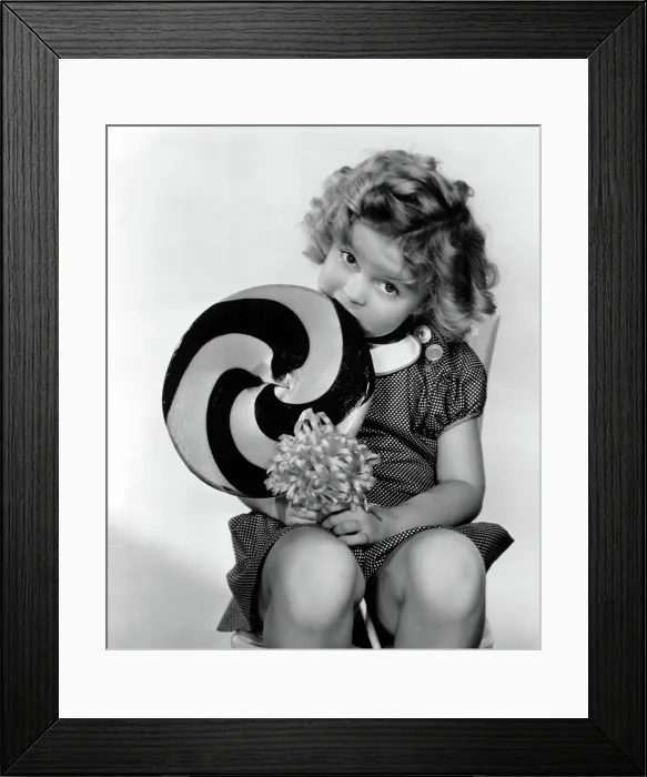 Framed Print : BRIGHT EYES, Shirley Temple, 1934, eating a big lollipop' TM and Copyright (c) 20th Century Fox Film Corp. All rights reserved. Courtesy: Everett Collection