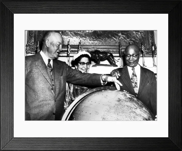 Framed Print : During a visit to the White House, Explorer Matt Henson helps President Eisenhower locate the spot on a globe where he reached the top of the North Pole exactly 45 years before