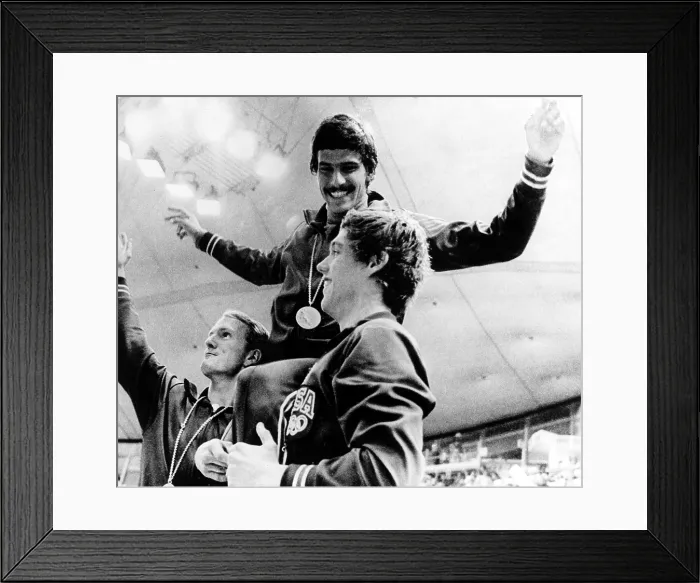 Framed Print : Mark Spitz shows off his 7th Gold Medal, supported by teammates Tom Bruce (L) and Mike Stamm (R), following the U.S Framed Print : Mark Spitz shows off his 7th Gold Medal, supported by teammates Tom Bruce (L) and Mike Stamm (R), following the U.S