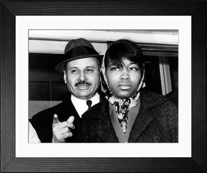 Framed Print : Mrs. Betty Little Shabazz (right), widow of Malcolm X, and her attorney, Percy Sutton, leaving the morgue after identifying the body of her husband. New York, February 22, 1965