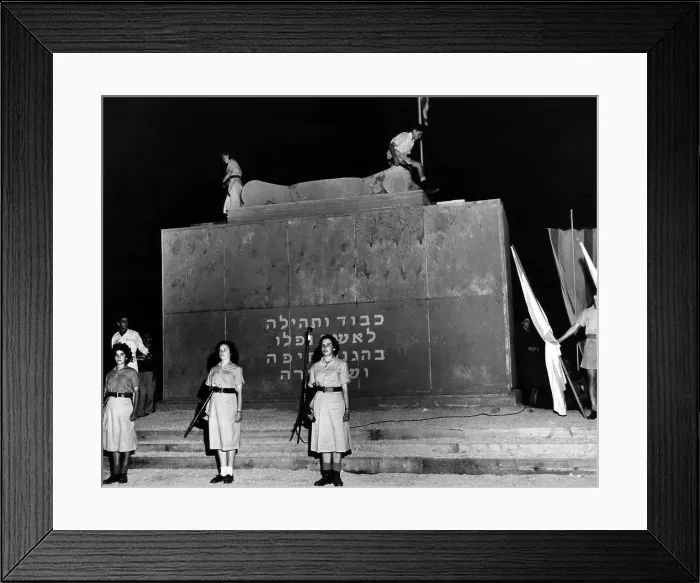 Framed Print : Two youths light the eternal flame on top of Haifa's monument honoring those killed in the battle for Haifa one year earlier