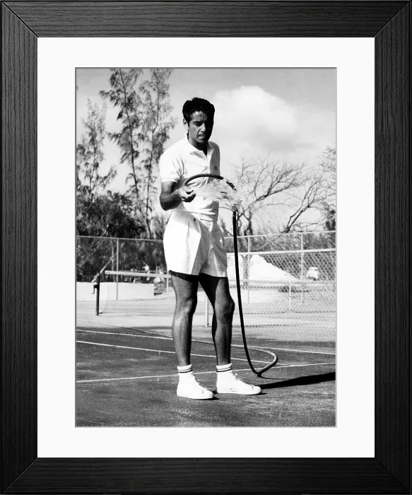 Framed Print : Tennis player Pancho Gonzales hosing off his courts in the Bahamas, 1962. Courtesy: CSU Archives / Everett Collection