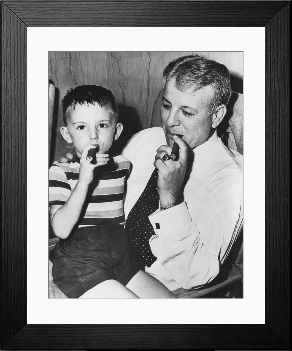 Framed Print : Frank Wilson, secretary- treasurer of Fulton-DeKalb Hospital Authority with five-year-old Jimmy Wingo, who has smoked cigars since he was three, Ataltna, GA, June, 1952