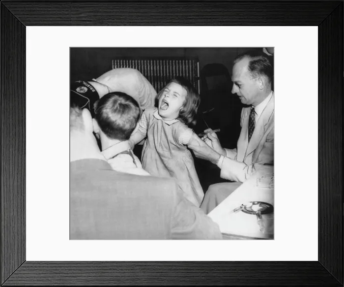 Framed Print : A young girl receiving a vaccine from Dr. Hugh Griffin (right), circa 1950s. Courtesy: CSU Archives / Everett Collection Framed Print : A young girl receiving a vaccine from Dr. Hugh Griffin (right), circa 1950s. Courtesy: CSU Archives / Everett Collection