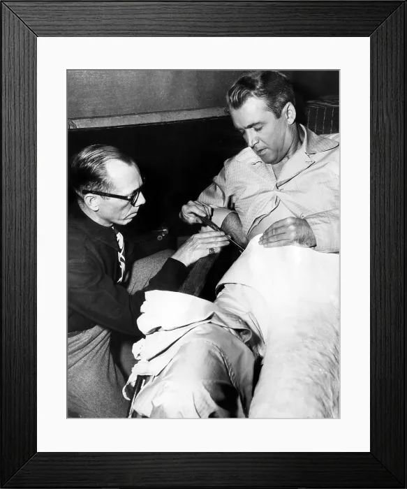 Framed Print : Prop man Bill Sapp screws James Stewart into a plaster cast on the set of Alfred Hitchcock's REAR WINDOW, 1954. CSU Archives courtesy / Everett Collection