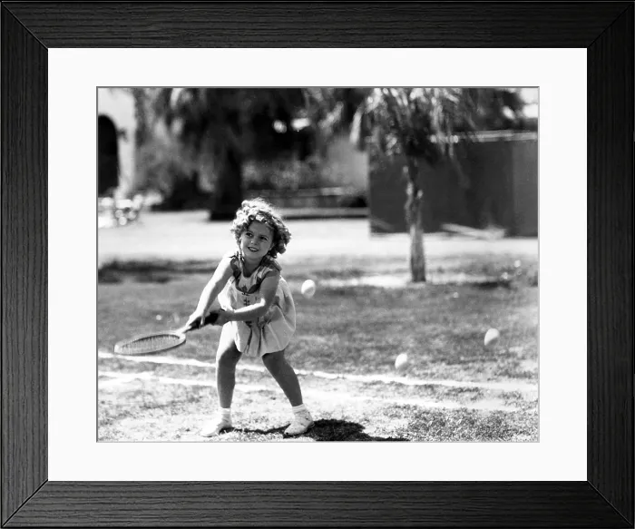 Framed Print : Shirley Temple, American actress, playing tennis, July 27, 1936. Courtesy: CSU Archives / Everett Collection