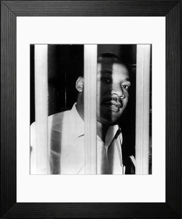 Framed Print : MARTIN LUTHER KING, JR, peers between the bars of his jail cell in the St. John's County Jail, Florida