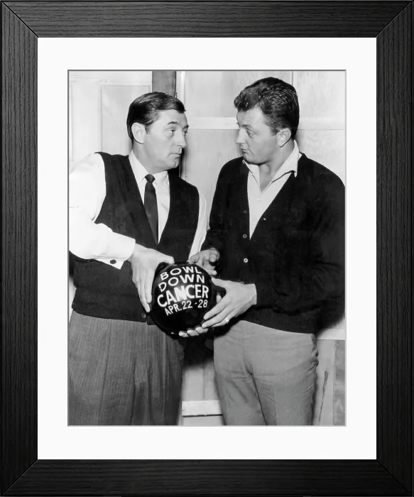 Framed Print : American actor Robert Mitchum and his son, Jim Mitchum, discussing Bowl Down Cancer Week, a week long bowling and cancer educational campaign, 1962