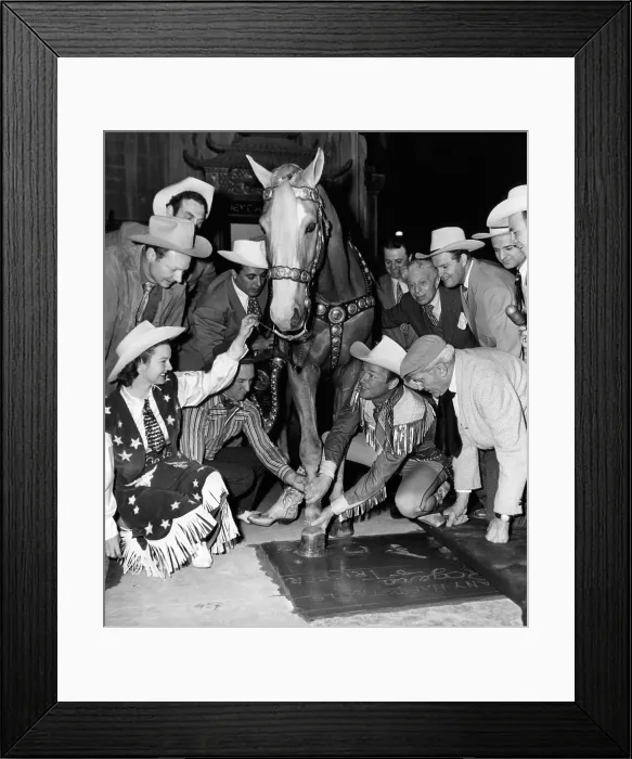 Framed Print : Western film star Roy Rogers (second from right), being honored at Grauman's Chinese Theater along with his horse Trigger, as his wife Dale Evans (foreground left) watches