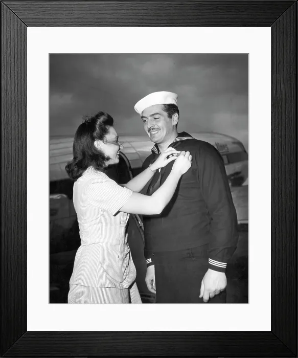 Framed Print : American actor and Coast Guardsman Victor Mature (right), receiving campaign ribbons from Juanita Ferrara (left), the Coast Guard Public Relations Secretary, 1943 Framed Print : American actor and Coast Guardsman Victor Mature (right), receiving campaign ribbons from Juanita Ferrara (left), the Coast Guard Public Relations Secretary, 1943