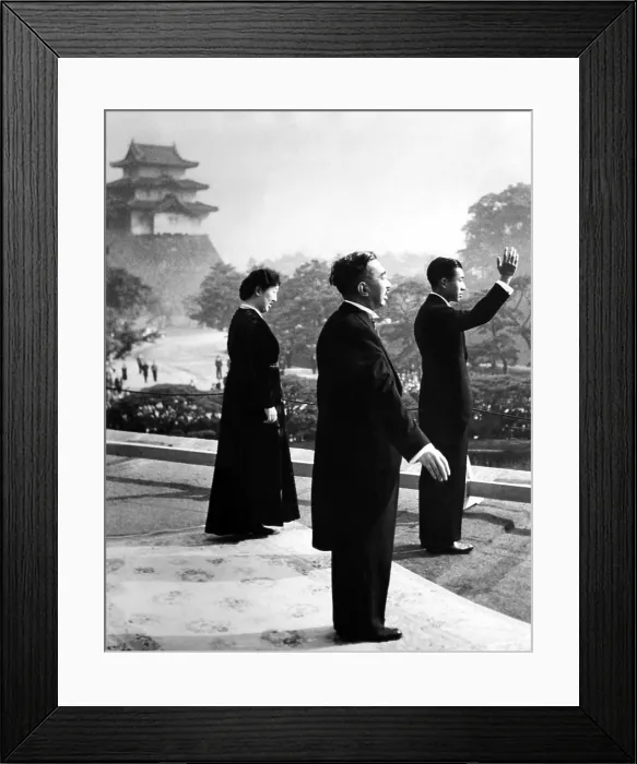 Framed Print : Crown Prince Akihito waves to cheering well wishers after he was proclaimed heir apparent to the throne. Behind him are his parents, Emperor Hirohito and Empress Nagako. ca. 1952