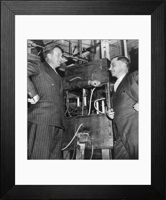 Framed Print : Ernest O. Lawrence, American physicist and Nobel Laureate, and Dr. Lee Alvin DuBridge (1901-1994), inspecting an atom smasher at the University of Rochester in Rochester NY