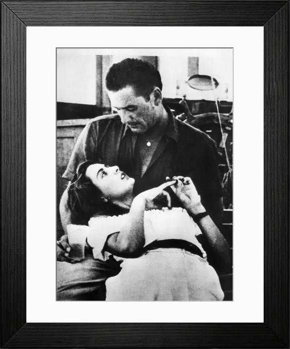 Framed Print : A possibly doctored photo reportedly showing 16 year old Danielle Darvin lying in the lap of actor Errol Flynn, Nice France, 1949. Courtesy of CSU Archives / Everett Collection