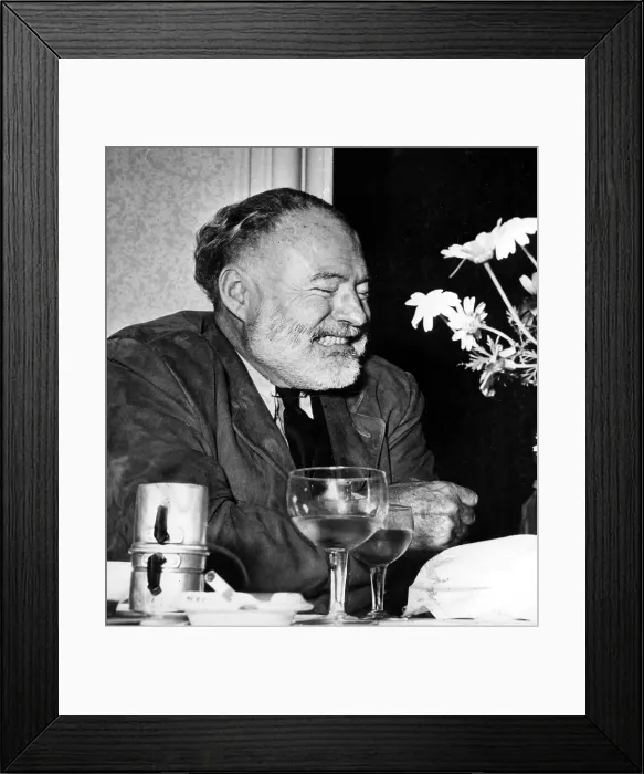 Framed Print : Ernest Hemingway drinks wine and coffee at a restaurant in Genoa, Italy. 06 / 07 / 54.. Courtesy: CSU Archives / Everett Collection Framed Print : Ernest Hemingway drinks wine and coffee at a restaurant in Genoa, Italy. 06 / 07 / 54.. Courtesy: CSU Archives / Everett Collection