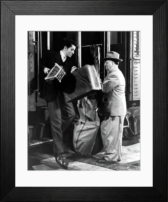 Framed Print : STRANGERS ON A TRAIN, director ALFRED HITCHCOCK makes a cameo appearance, oblivious to FARLEY GRANGER, 1951