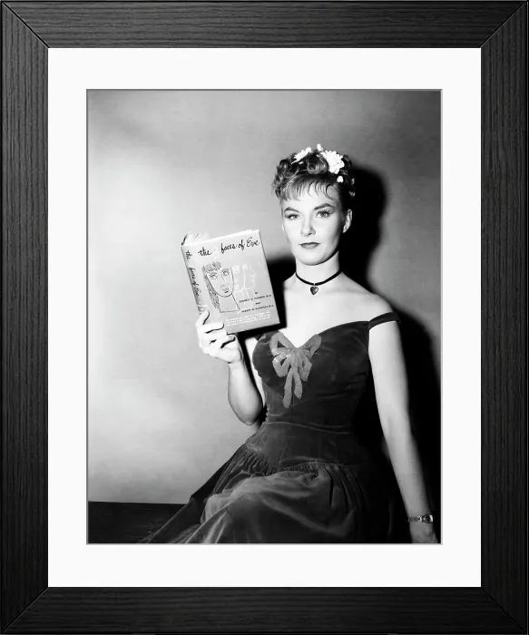 Framed Print : Publicity shot of star JOANNE WOODWARD holding a copy of the bestseller, THE THREE FACES OF EVE, 1957, TM and Copyright (c) 20th Century-Fox Film Corp. All Rights Reserved