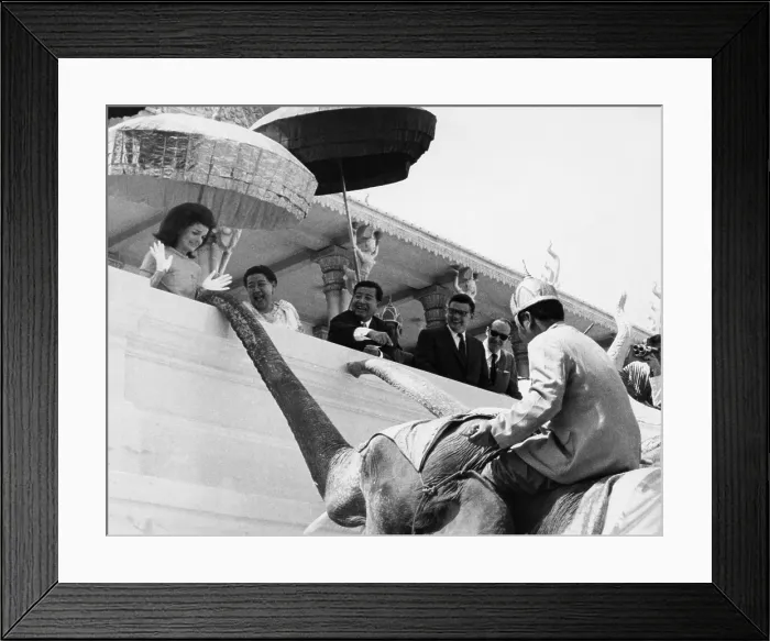 Framed Print : Jacqueline Kennedy (left) jumps in amazement as a royal elephant extends his trunk