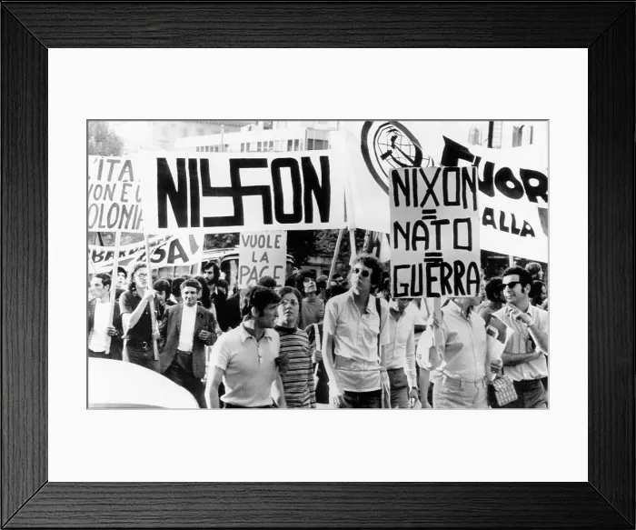 Framed Print : Italian anti-Nixon demonstrators march in anticipation of President Richard Nixon's visit. One of the signs displayed spelled Nixon with a swastika replacing the x Framed Print : Italian anti-Nixon demonstrators march in anticipation of President Richard Nixon's visit. One of the signs displayed spelled Nixon with a swastika replacing the x