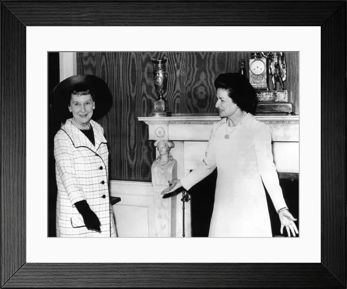 Framed Print : Former First Lady Mamie Eisenhower is welcomed by Lady Bird Johnson for the annual luncheon for the Senate ladies. The occasion used the new White House china for the first time