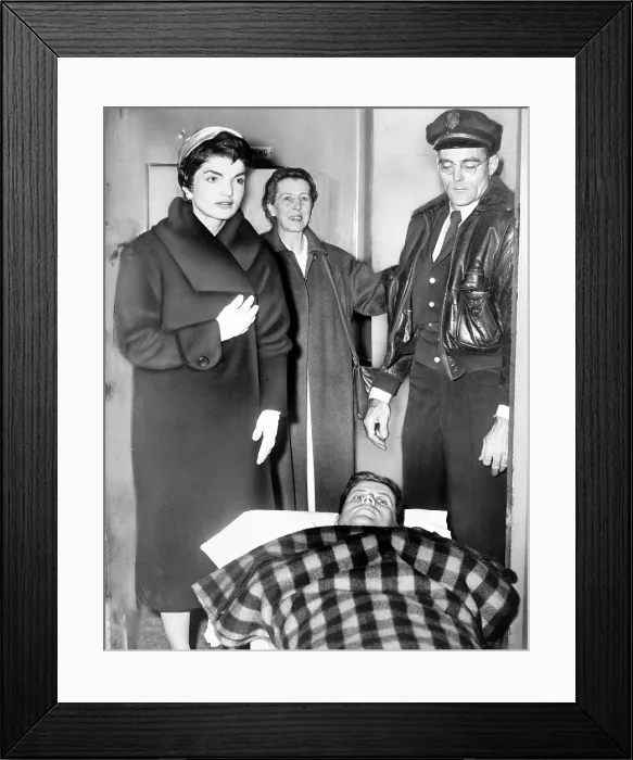Framed Print : John F. Kennedy leaving on gurney from hospital following spinal surgery, as his wife Jacqueline stands over him. Photo by Dick DeMarsico December 21, 1954