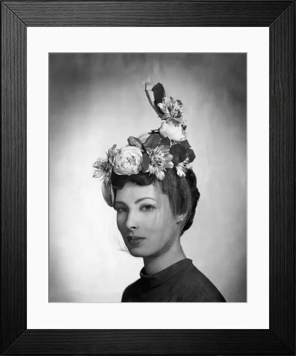 Framed Print : A model wearing a hat by Lilly Dache made of gray linen straw with yellow roses and passion flowers and a light veil under the chin. From Lilly Dache's Spring 1948 collection Framed Print : A model wearing a hat by Lilly Dache made of gray linen straw with yellow roses and passion flowers and a light veil under the chin. From Lilly Dache's Spring 1948 collection