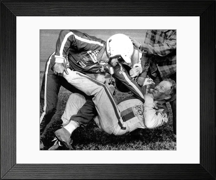Framed Print : Bobby Allison (L)fights with Cale Yarborough (R) after a collision between Allison and Yarborough on the final lap of the race cost Allison the victory