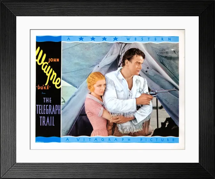 Framed Print : THE TELEGRAPH TRAIL, US lobbycard, from left: Marceline Day, John Wayne, 1933