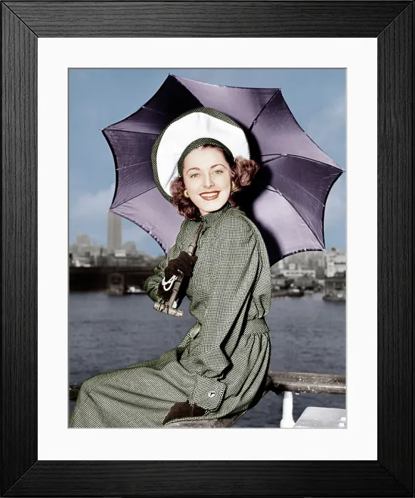 Framed Print : Eleanor Parker sports a new English umbrella as she arrive in N.Y. about the Queen Elizabeth, June 1948