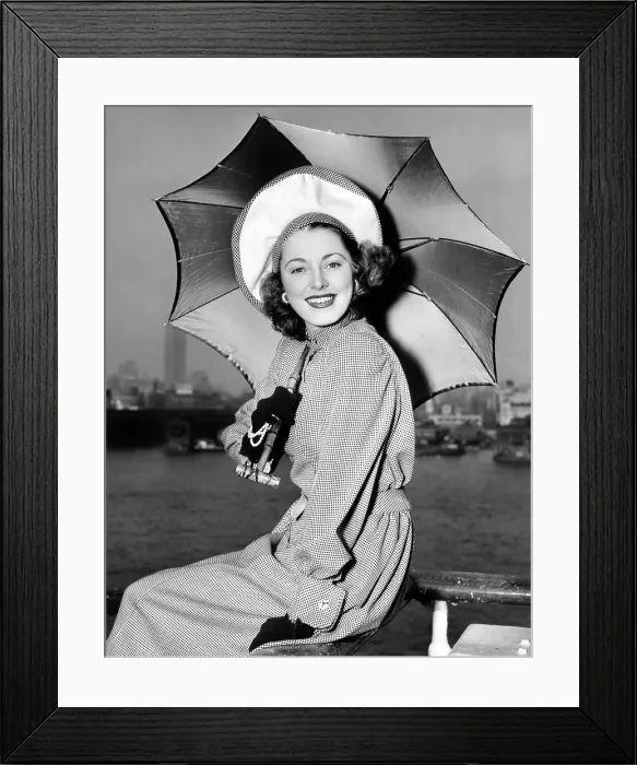 Framed Print : Eleanor Parker sports a new English umbrella as she arrives in N.Y. aboard the Queen Elizabeth, June 1948