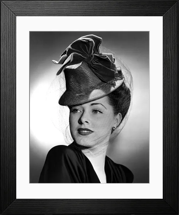 Framed Print : ELEANOR PARKER wearing a tall crowned chapeua made of felt with velvet bows, 1943 Framed Print : ELEANOR PARKER wearing a tall crowned chapeua made of felt with velvet bows, 1943