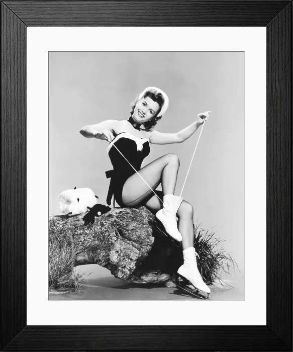 Framed Print : Debbie Reynolds lacing up her ice skates, 1950s