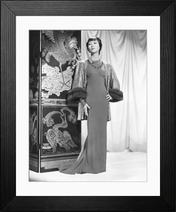 Framed Print : Anna May Wong in an Edith Head-designed crepe dinner gown with a jacket of emerald, green and gold lame trimmed with sable, Paramount portrait, 1937