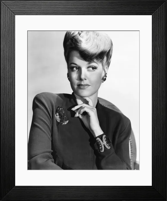 Framed Print : Ann Sheridan wearing a clip of diamonds and sapphires in gold and a heavy diamond and gold bracelet, 1941