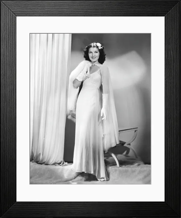 Framed Print : Jean Parker, modeling a white chiffon evening gown with a rhinestone-buckled cape and white fox throw, 1937