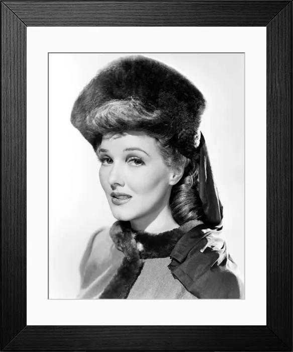 Framed Print : Jean Parker, modeling a beaver hat with brown silk jersey drapery, 1941