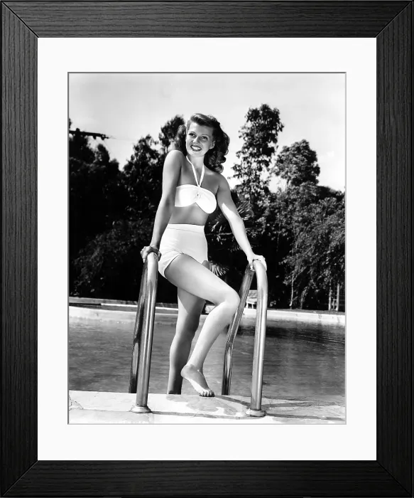 Framed Print : RITA HAYWORTH relaxes at home via a dip in the pool, 1946