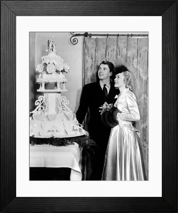 Framed Print : RONALD REAGAN and JANE WYMAN admire the cake at their wedding reception, 1 / 26 / 40