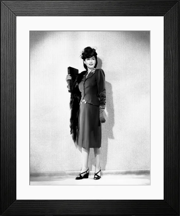 Framed Print : Maria Montez, modeling a brown gabardine suit accented in beige, with a sable hat and scarf, 1943