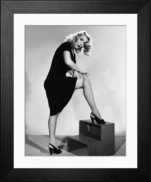 Framed Print : Marie Wilson, showing how to forgo garters by rollings your stockings, ca. 1940s Framed Print : Marie Wilson, showing how to forgo garters by rollings your stockings, ca. 1940s