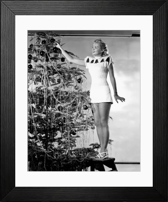 Framed Print : Myrna Dell decorating the Christmas Tree, RKO portrait, circa 1946