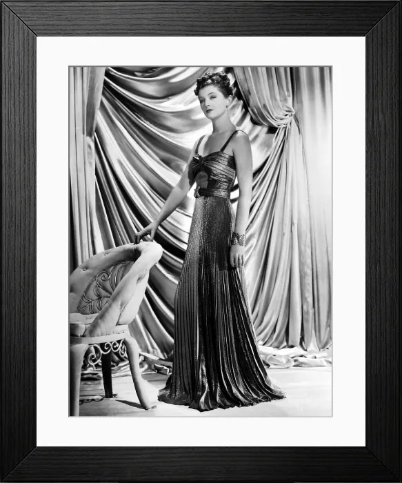 Framed Print : Myrna Loy wearing green and yellow gold pleated metallic evening gown, 1938