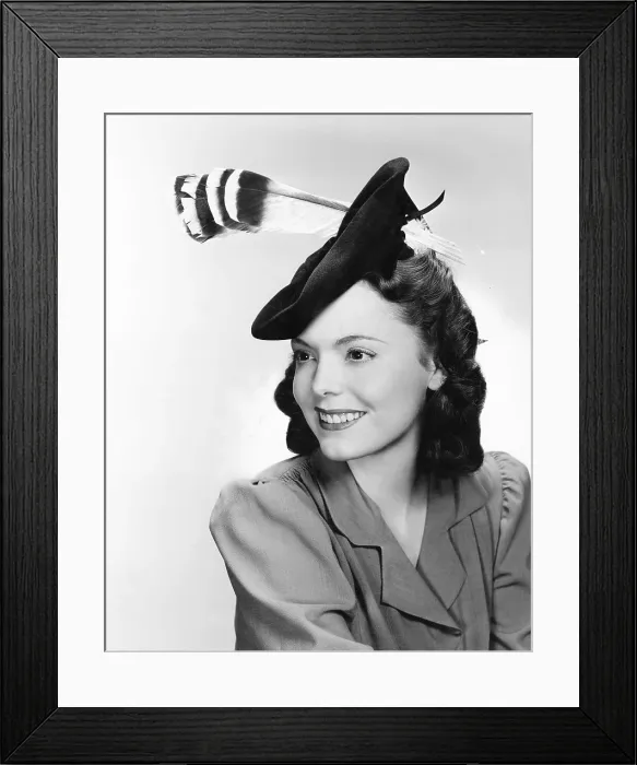 Framed Print : Warner Bros. starlet Nancy Coleman, modeling a green felt beret with a grey and black aigrette, 1942