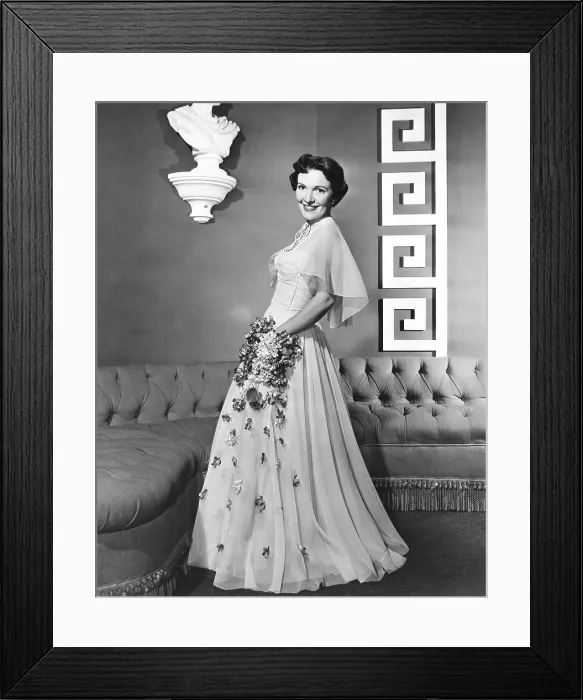 Framed Print : Nancy Davis, (aka Nancy Reagan), modeling a lavendar nylon gown with rhinestone-spangled flowers, 1950