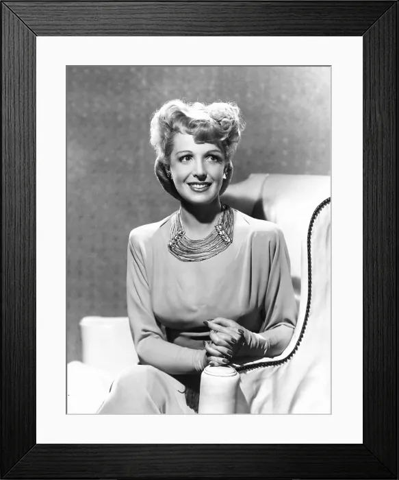 Framed Print : Natalie Schafer, modeling a necklace made of beige fringe and gold beads, 1944