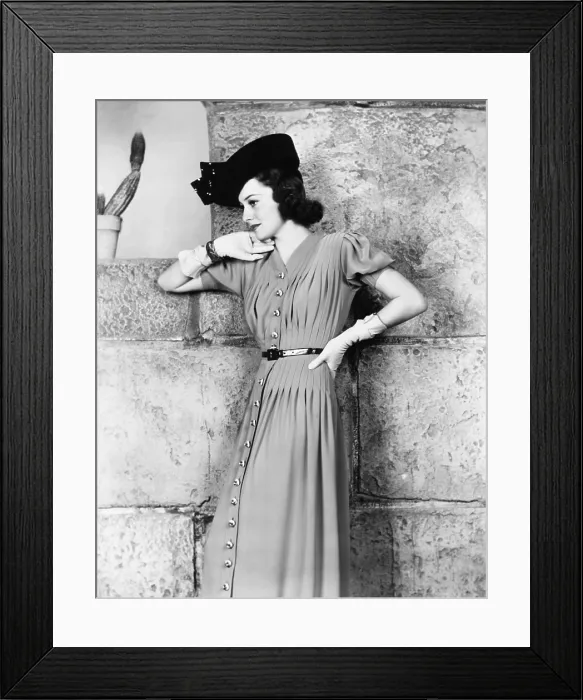 Framed Print : Olivia de Havilland, in a blue dress with wooden buttons and navy straw hat, 1939