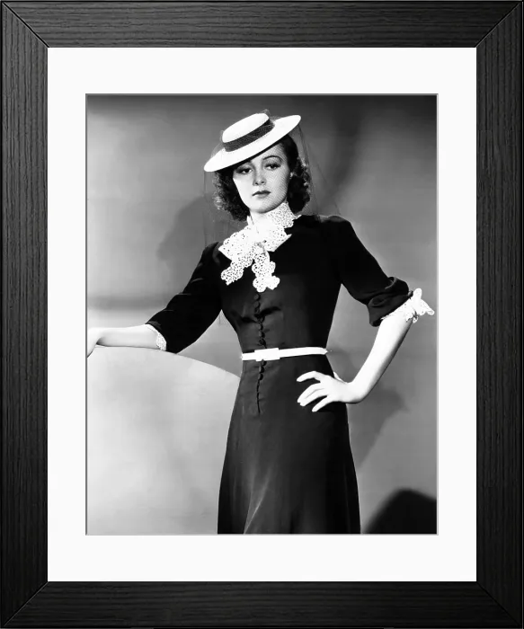 Framed Print : Olivia de Havilland, modeling a spring frock of navy-blue bengaline with white accents, and a felt boater hat, 1939